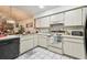 Bright kitchen with white cabinets and appliances, offering a functional cooking space at 23227 Club Villas Dr # 38, Land O Lakes, FL 34639