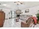 Cozy living space featuring a stone fireplace, comfortable sofa, and tiled flooring at 23227 Club Villas Dr # 38, Land O Lakes, FL 34639