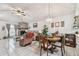 Bright living area with a stone fireplace, dining table, and view into an adjacent room at 23227 Club Villas Dr # 38, Land O Lakes, FL 34639