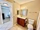 Bathroom featuring tiled floors, a cherry vanity with sink, and a toilet at 2400 Feather Sound Dr # 1016, Clearwater, FL 33762