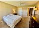 Bedroom featuring large dresser, ceiling fan, and access to a bathroom at 2400 Feather Sound Dr # 1016, Clearwater, FL 33762