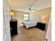 Clean bedroom with carpet flooring, ceiling fan, and view to the outdoors at 2400 Feather Sound Dr # 1016, Clearwater, FL 33762