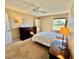 Bright bedroom with a ceiling fan, carpet flooring, and large window at 2400 Feather Sound Dr # 1016, Clearwater, FL 33762