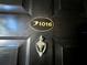 Dark front door with a gold unit number and an antique knocker at 2400 Feather Sound Dr # 1016, Clearwater, FL 33762