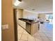 Kitchen with stainless steel appliances and a breakfast bar that overlooks the living room at 2400 Feather Sound Dr # 1016, Clearwater, FL 33762