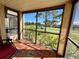 Relaxing screened-in lanai with tile flooring overlooking the golf course with mature trees and view of the fairway at 2400 Feather Sound Dr # 1016, Clearwater, FL 33762