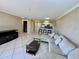 Spacious living room with comfortable seating, glass coffee table, and open access to the kitchen at 2400 Feather Sound Dr # 1016, Clearwater, FL 33762