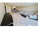 Bright, open living room with comfortable seating, breakfast bar, and tile flooring at 2400 Feather Sound Dr # 1016, Clearwater, FL 33762