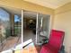 Tiled porch with open sliding glass doors to the interior at 2400 Feather Sound Dr # 1016, Clearwater, FL 33762