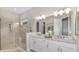 Luxurious bathroom featuring a double vanity, tiled shower, and modern fixtures at 26842 Dove Dr, Punta Gorda, FL 33955
