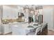 Modern kitchen featuring a large island with seating, pendant lighting, and state-of-the-art appliances at 26842 Dove Dr, Punta Gorda, FL 33955