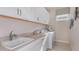 Functional laundry room with ample cabinetry, a sink, modern washer and dryer, and a bright, clean aesthetic at 26842 Dove Dr, Punta Gorda, FL 33955