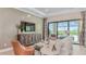 Relaxing living room area with a large couch, chairs, and a view of the outdoor pool at 26842 Dove Dr, Punta Gorda, FL 33955