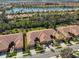 Community aerial showcasing the neighborhood's layout with homes near a picturesque lake and lush greenery at 320 Seneca Falls Dr, Apollo Beach, FL 33572