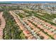 Aerial view featuring a community layout with uniform terracotta roofs, complemented by lush greenery and streets at 320 Seneca Falls Dr, Apollo Beach, FL 33572
