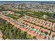 Expansive aerial view showcasing a residential community with terracotta roofs and lush landscaping near a coastal area at 320 Seneca Falls Dr, Apollo Beach, FL 33572