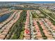 Community aerial featuring terracotta roofs, serene lakes, and manicured landscapes from an elevated perspective at 320 Seneca Falls Dr, Apollo Beach, FL 33572