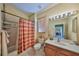 Bathroom featuring a shower-tub combo, vanity with a sink, toilet, and a mirror at 320 Seneca Falls Dr, Apollo Beach, FL 33572