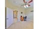Bedroom featuring a ceiling fan, office space, and a well-lit ambiance at 320 Seneca Falls Dr, Apollo Beach, FL 33572