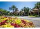 Community center featuring lush landscaping, palm trees, and architectural details in a vibrant neighborhood setting at 320 Seneca Falls Dr, Apollo Beach, FL 33572