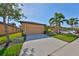 Exterior view of a well-maintained home with an attached garage and a manicured lawn at 320 Seneca Falls Dr, Apollo Beach, FL 33572