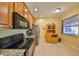 Bright kitchen with stainless steel appliances, tile floors, granite counters, and built in hutch at 320 Seneca Falls Dr, Apollo Beach, FL 33572
