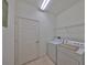 Laundry room with a washer, dryer, and overhead shelving for convenient storage at 320 Seneca Falls Dr, Apollo Beach, FL 33572