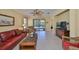 Comfortable living room features tile flooring, ceiling fan, and sliding glass doors to lanai at 320 Seneca Falls Dr, Apollo Beach, FL 33572