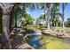 Scenic community pond with a small waterfall feature, rocks, and lush greenery, creating a tranquil setting at 320 Seneca Falls Dr, Apollo Beach, FL 33572