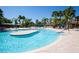 Inviting pool area with wading platform, lush greenery, and plenty of seating for a relaxing day at 320 Seneca Falls Dr, Apollo Beach, FL 33572