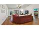 Cozy living room featuring hardwood floors, a comfortable seating arrangement, and abundant natural light at 360 Wellington Ave, Oldsmar, FL 34677