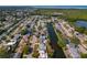 Aerial view of a charming single-story home with a well-maintained yard and water access at 3823 Sail Dr, New Port Richey, FL 34652