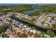 Aerial view of a charming single-story home with a well-maintained yard and water access at 3823 Sail Dr, New Port Richey, FL 34652