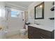 Bright bathroom with a shower-tub, white tile, modern vanity, and decorative mirror and accessories at 3823 Sail Dr, New Port Richey, FL 34652