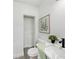 Modern bathroom featuring a toilet, sink, and a framed botanical wall art print at 407 Cranberry Ln, Brandon, FL 33510