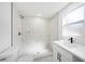 Modern bathroom featuring a stand-up shower with marble-look tiles and a vanity sink at 407 Cranberry Ln, Brandon, FL 33510