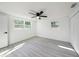 Spacious bedroom with wood-look floors, a ceiling fan, and bright natural light at 407 Cranberry Ln, Brandon, FL 33510