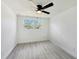 Comfortable bedroom with neutral walls, wood-look floors, and a lighted ceiling fan at 407 Cranberry Ln, Brandon, FL 33510