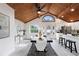 Dining room with vaulted wood ceilings open to the modern white kitchen at 407 Cranberry Ln, Brandon, FL 33510