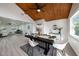 Dining room with vaulted wood ceilings adjacent to the kitchen and living room at 407 Cranberry Ln, Brandon, FL 33510