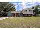 Charming two-story home featuring a brick facade, blue door, and well-maintained lawn at 407 Cranberry Ln, Brandon, FL 33510