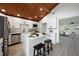 Open kitchen features a center island, stainless steel appliances, and a view into the adjacent living room at 407 Cranberry Ln, Brandon, FL 33510
