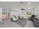 Stylish living room featuring modern gray flooring, white walls, and comfortable seating at 407 Cranberry Ln, Brandon, FL 33510