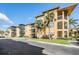 Attractive condo building with tan facade, multiple balconies, and lush landscaping on a sunny day at 4323 Bayside Village Dr # 314, Tampa, FL 33615