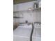 Laundry room features new washer and dryer with upper shelving for storage and organization at 4323 Bayside Village Dr # 314, Tampa, FL 33615