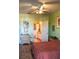 Relaxing bedroom with hardwood floors, artwork, and adjacent ensuite bathroom at 4323 Bayside Village Dr # 314, Tampa, FL 33615