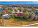 Expansive aerial view of a beautiful property and golf course community with lush landscaping and scenic ponds at 5035 Pinelake Rd, Wesley Chapel, FL 33543