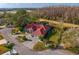 Aerial view of a home with mature landscaping, driveway and a red tile roof at 5035 Pinelake Rd, Wesley Chapel, FL 33543