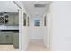 Hallway with recessed lighting and art leading to a prep area with gray cabinets at 5035 Pinelake Rd, Wesley Chapel, FL 33543