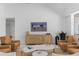 Bright living room with wood entertainment center and leather chairs at 5035 Pinelake Rd, Wesley Chapel, FL 33543